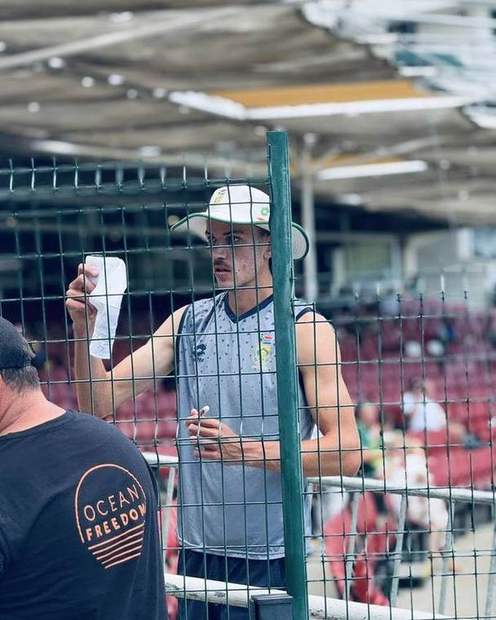 A player signing for fans at the fence